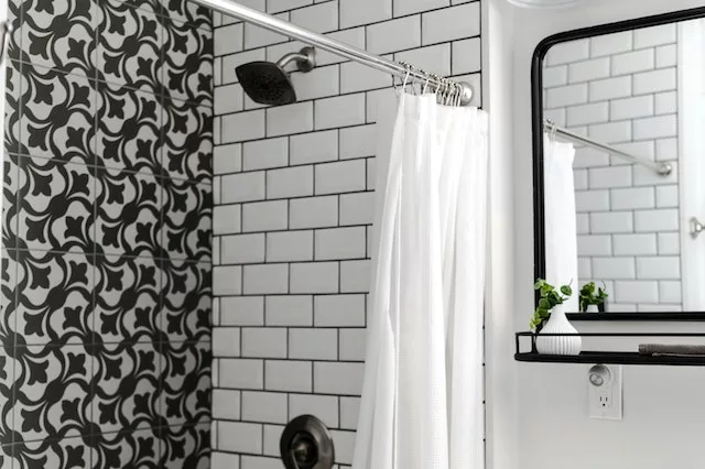 white tile in the shower that matches the white curtain